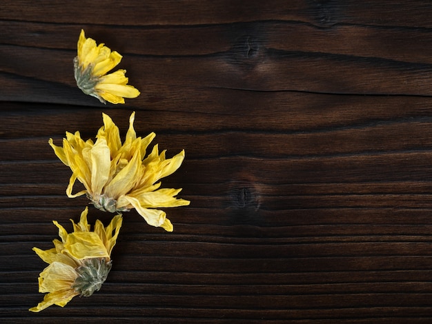 Flowers on dark wooden background,flat lay