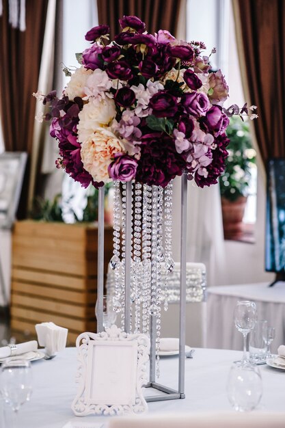 Flowers on a festive table at the wedding banquet hall