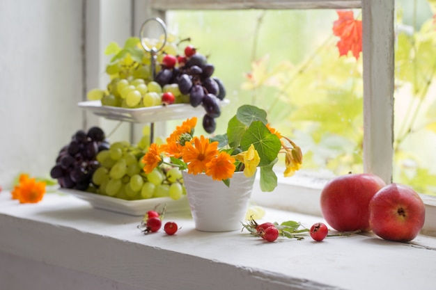 Flowers and fruits on windowsill