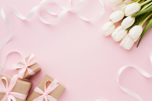 Flowers and gift boxes with ribbon top view