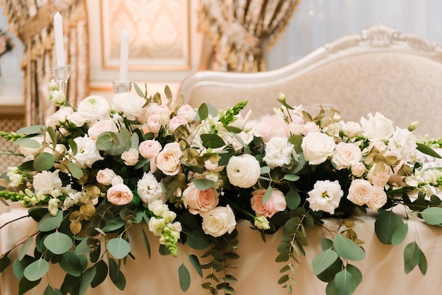 Flowers in a Golden vase on a luxurious holiday table