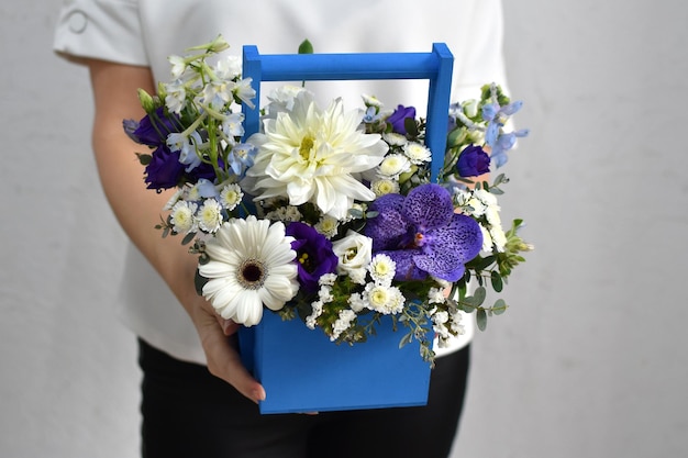 Flowers in hat box woman with a bouquet of flowers online catalog of flower delivery shop plant composition