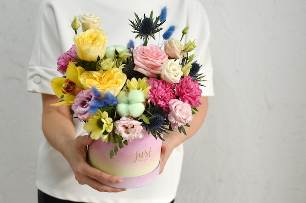 Flowers in hat box woman with a bouquet of flowers online catalog of flower delivery shop plant composition