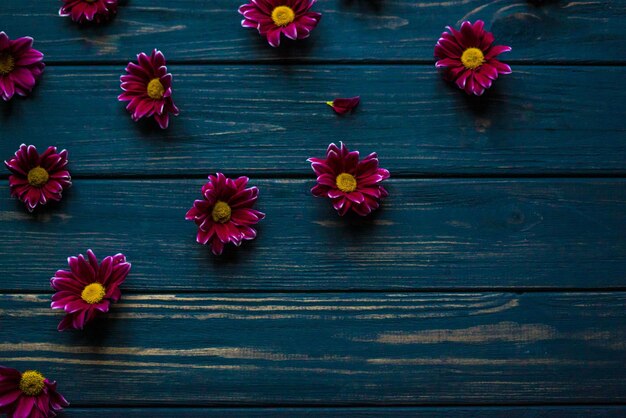 Flowers lie on a wooden blue table