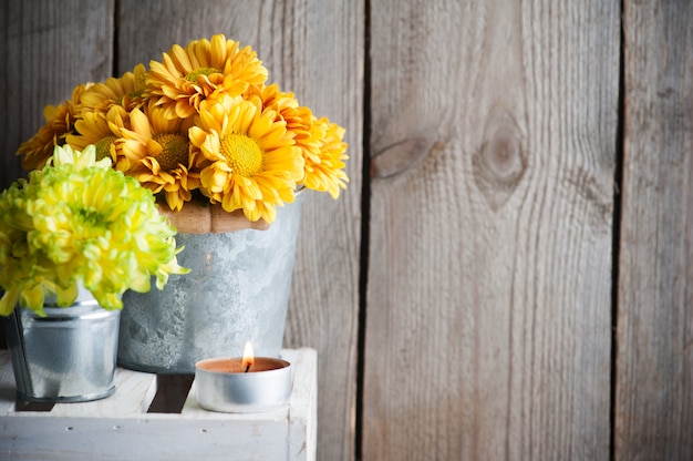 Flowers and lit candle interior