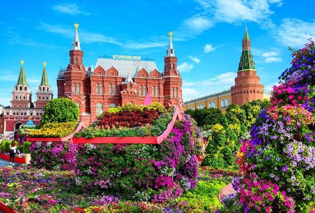 Flowers in Moscow Russia Scenic view of Historical Museum it's written on roof and Moscow Kremlin in background