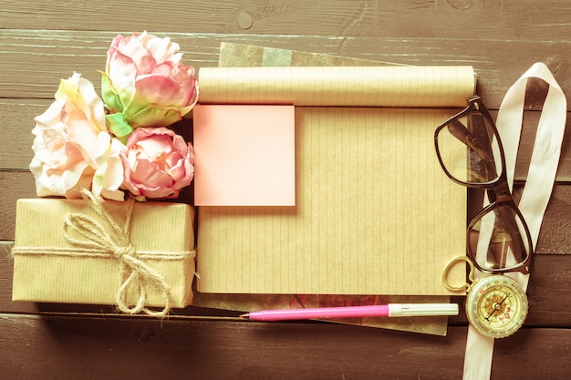 Flowers and a notebook on wooden