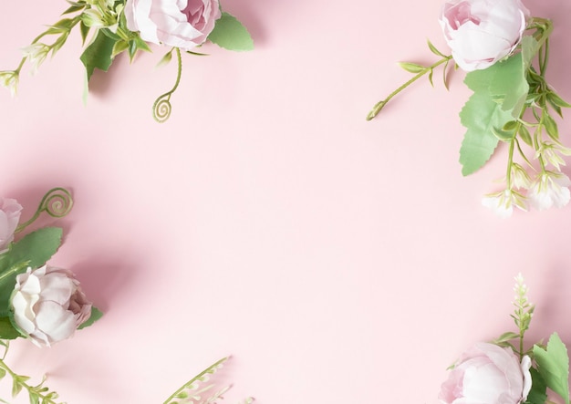 Flowers on a pink background are arranged in the corners of a pink background ..