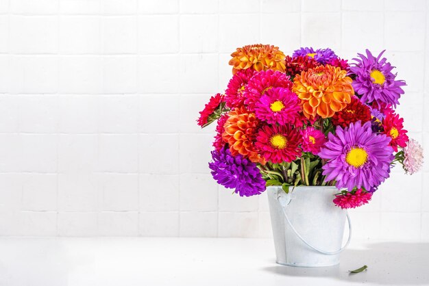 Flowers and pumpkins on table