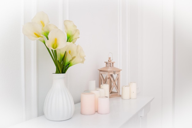 Flowers in a vase and candles in the interior