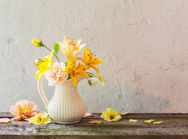 Flowers in vase on old white background