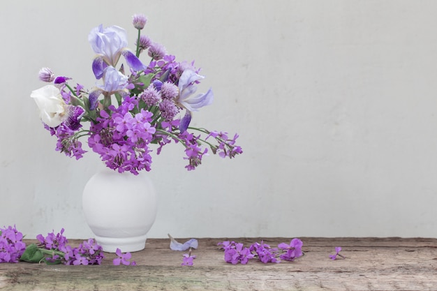 Flowers in vase on white wall