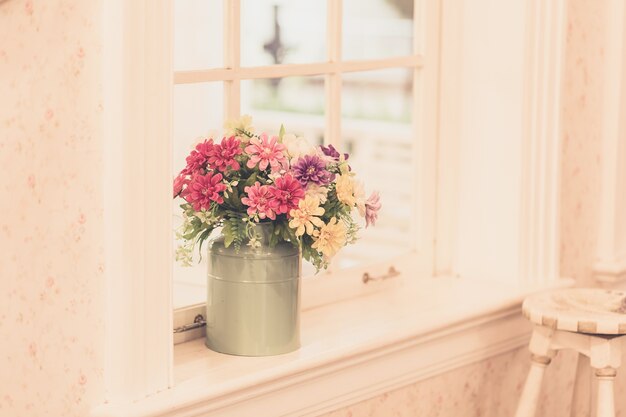 Photo flowers in vase on window