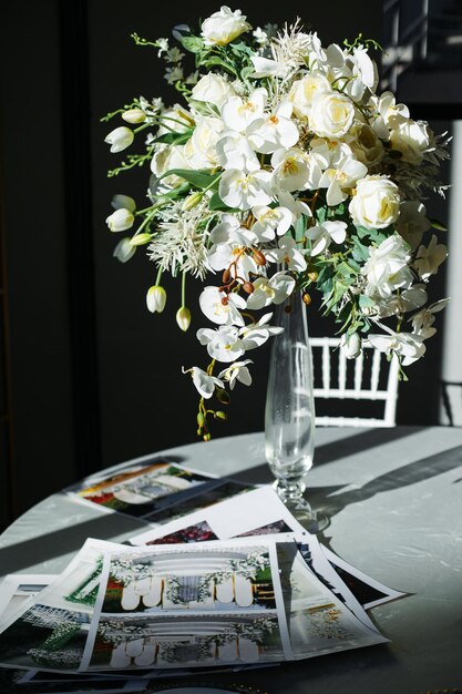 Photo flowers and wedding arch design layout on the table by the window