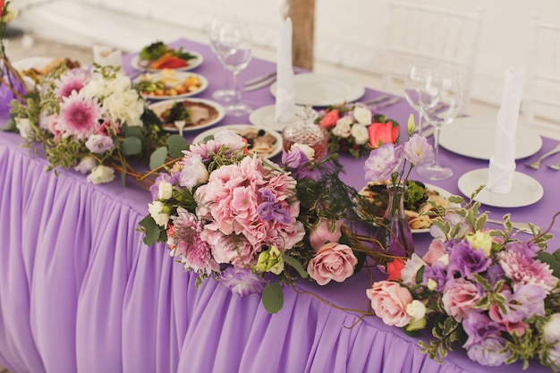 The flowers at the wedding table. Tent.