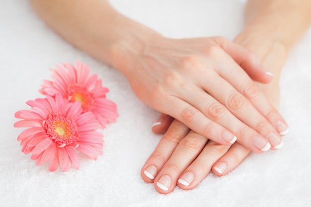 Flowers with french manicured fingers