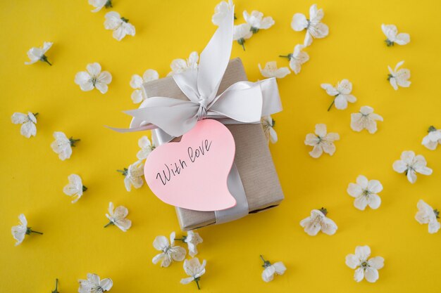 Flowers with wrapped gift and with love tag