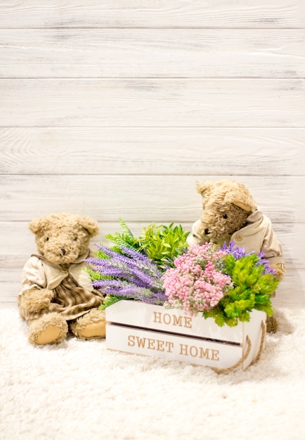 Flowers in a wooden box and cute bears. Flowers in a white box, plush vintage bears. Roman