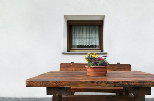 Flowers on a wooden table by the window