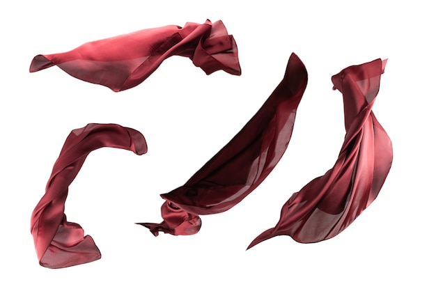 Photo flowing red silk scarf isolated on white background.