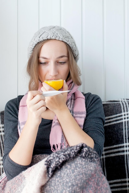 Flu cold grippe Woman having high temperature Sick girl with fever checking mercury thermometer