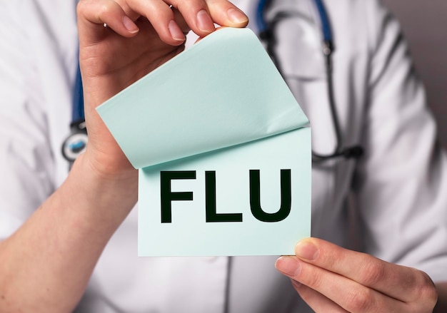 Flu or influenza inscription, word in doctor hands