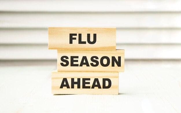 FLU SEASON AHEAD text on wooden block.