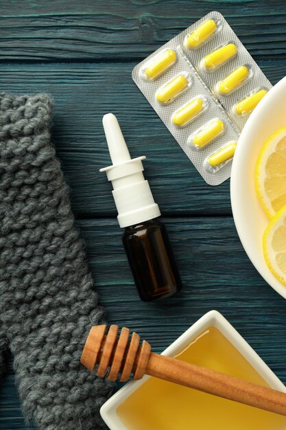 Flu treatment accessories on wooden table, top view