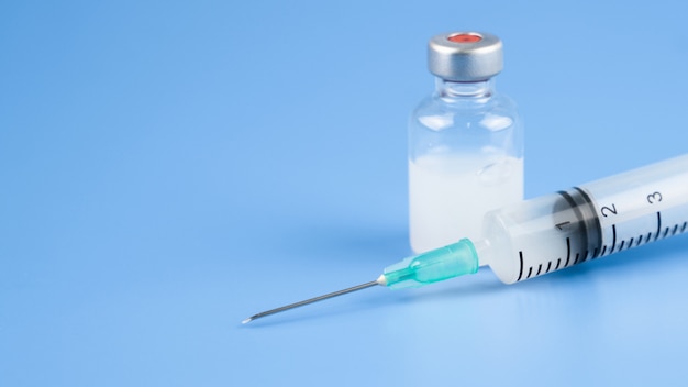 Flu vaccine bottle, syringe injection vial dose or vitamin for baby vaccination  