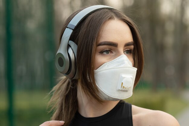 Flu virus protection mask protective against influenza sickness viruses and disease. Sick woman wearing face mask in public spaces. 