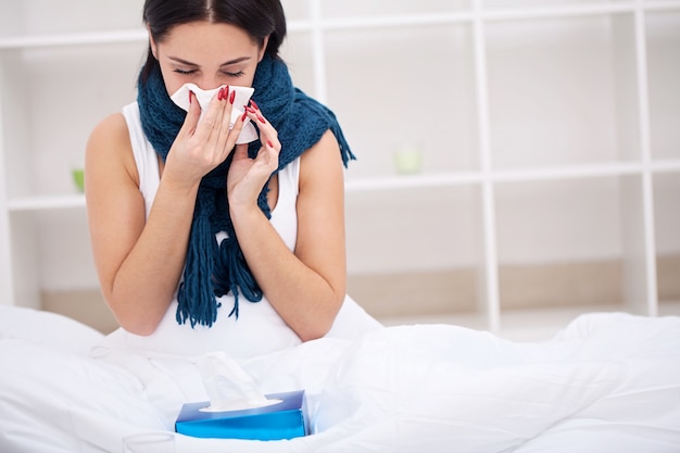 Flu. Woman Suffering From Cold Lying In Bed With Tissue