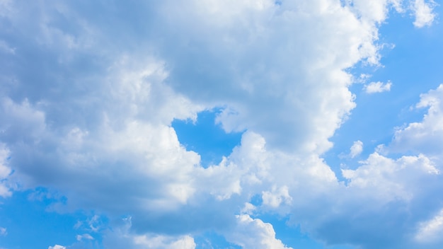 Fluffy clouds on a blue sky background