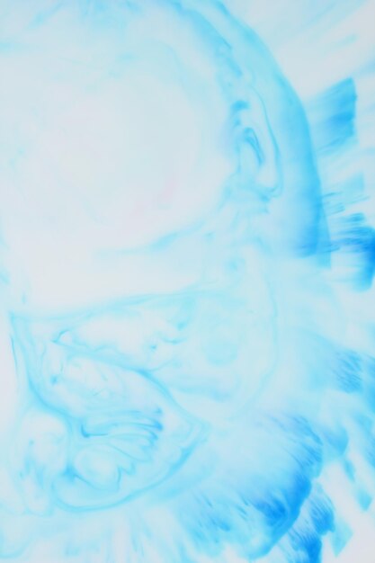 Fluid art. Blue ink dissolved in water. Abstract formed by color dissolving in water