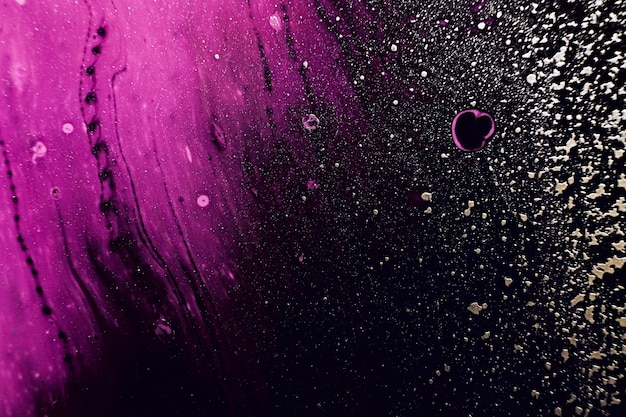 Fluid Art Golden spray particles and purple waves on black background Marble effect background or texture