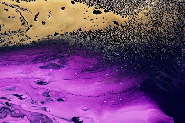 Fluid Art Metallic gold abstraction on purple waves Marble effect background or texture