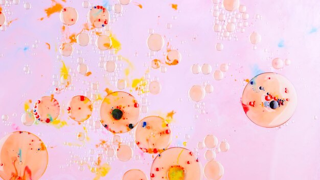 Fluid art multicolored background with oil on liquid abstract golden pink background