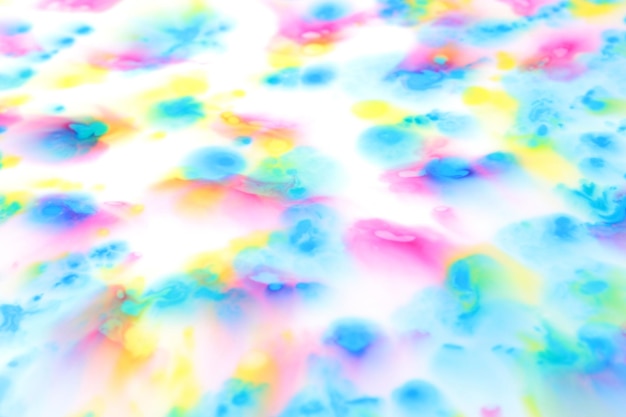 Fluid art Pink yellow and blue spots on a white background Abstract background with splashes of pink yellow and blue color