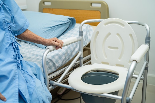 Flush toilet and shower chair in bathroom for old elder people