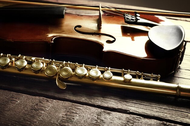 Flute with violin on table close up