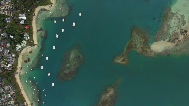 Flying over blue ocean and coast of mauritius island