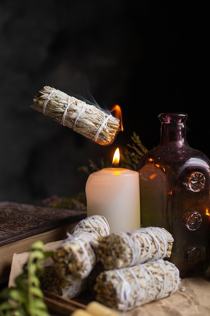 flying burning sage over a candle . the magic altar