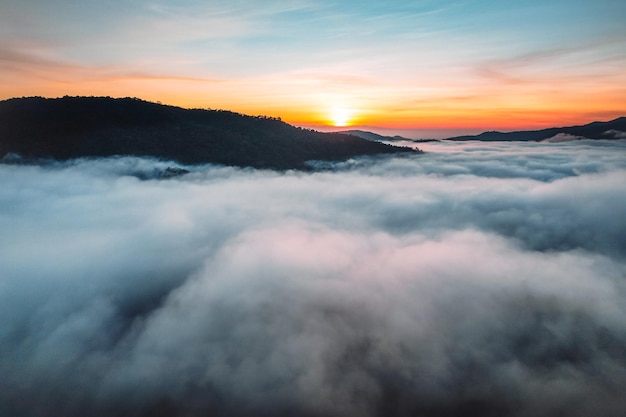 Flying above the clouds sunrise and fog,on the hill