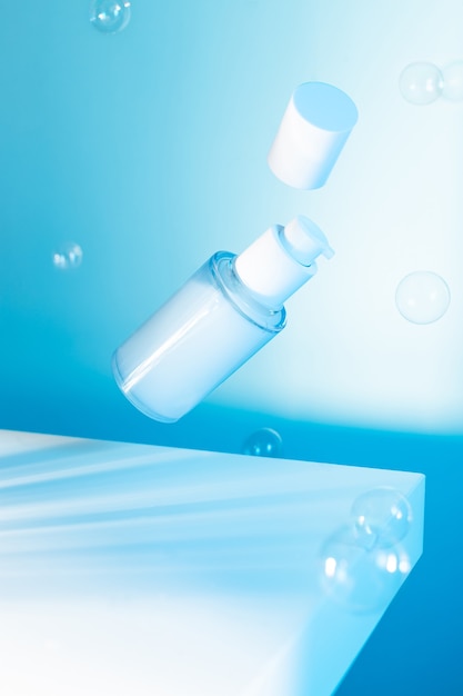 Flying cosmetic serum bottle on a blue background, neon light, mock up image