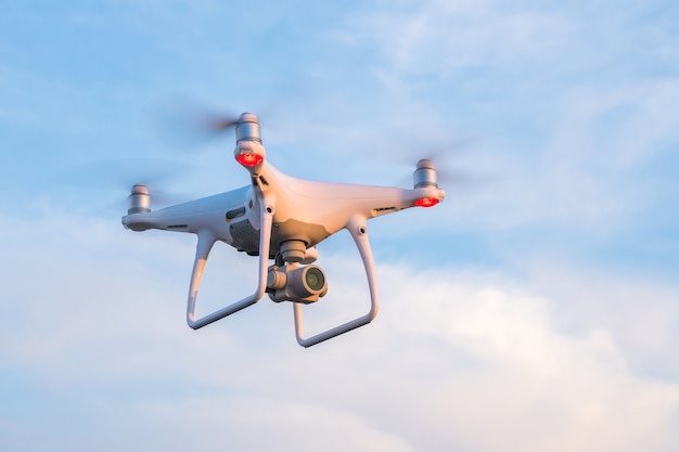 Flying drone with blue sky.