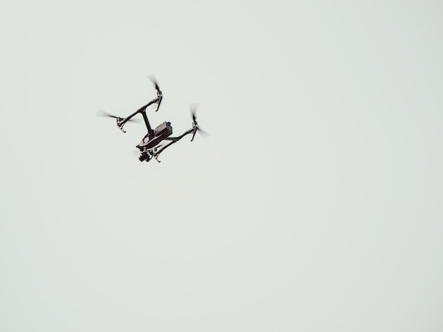 Flying handmade drone on sky.