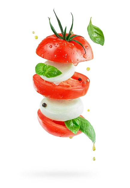Flying italian salad caprese with mozzarella cheese, tomatoes and basil