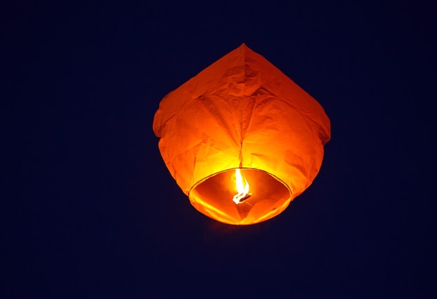 Flying lantern in the dark sky