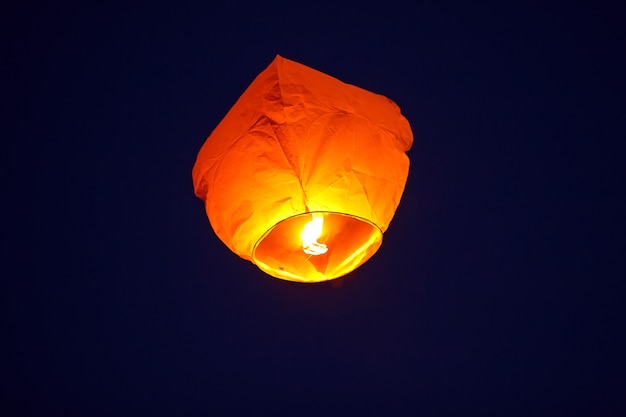 Flying lantern in the dark sky