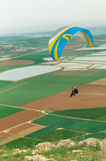 Flying on a parachute over the meadows