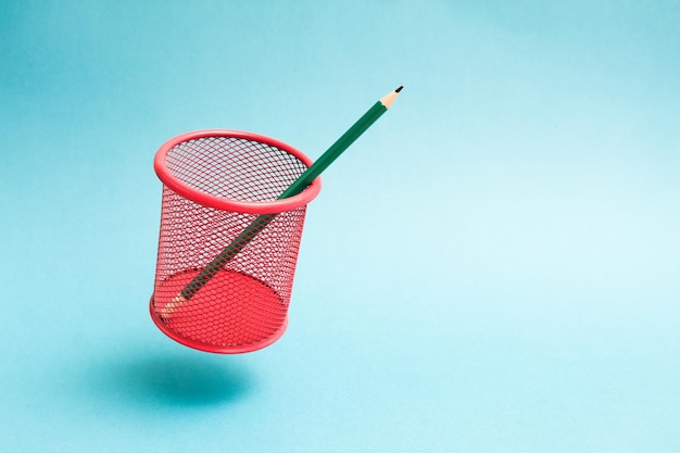 Flying red mesh pencil cup with a single pencil